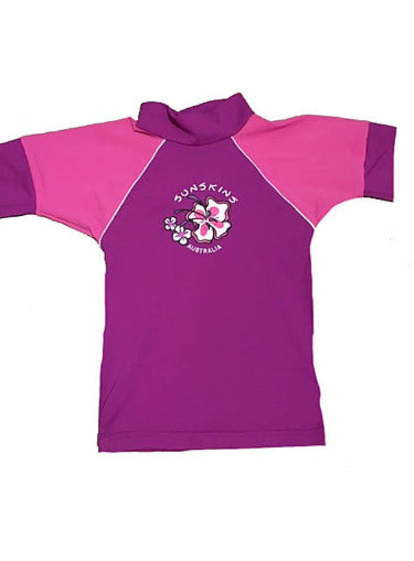 Girls Rash Shirt in chlorine resistant fabric, predominantly pink with light pink short sleeves, featuring a graphic on the front.
