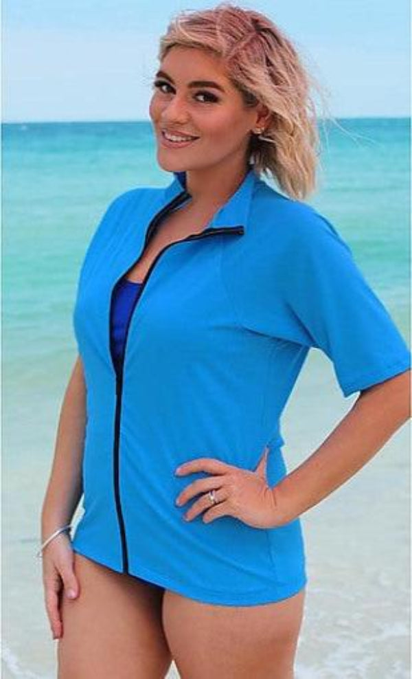 Women wearing zip front blue rash guard at the beach