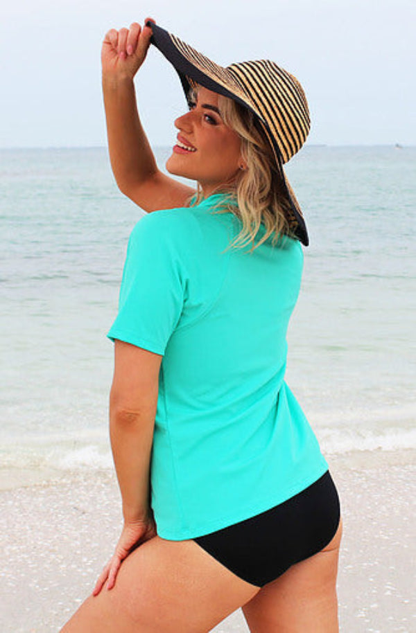 Woman wearing green rashie shirt