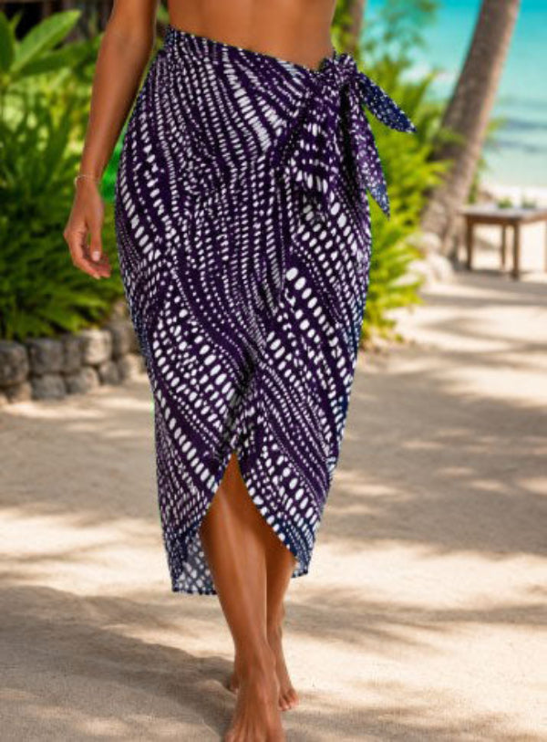 Woman wearing a purple and white patterned resort sarong wrap