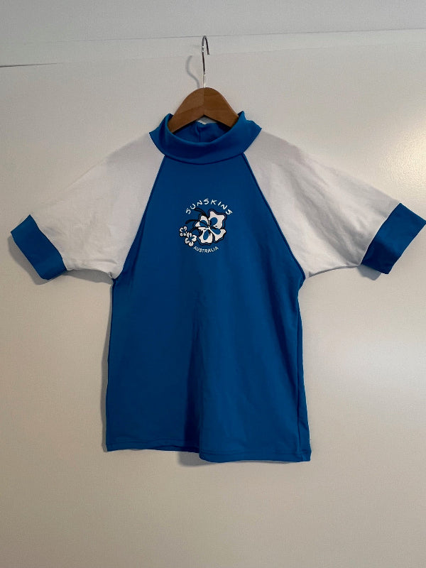 Blue and white rash guard shirt with a flower sunskins Australia logo 